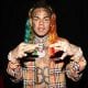 The Streets Doesn't F*ck With Tekashi 6ix9ine, Man Tears Rapper's Album Posters 